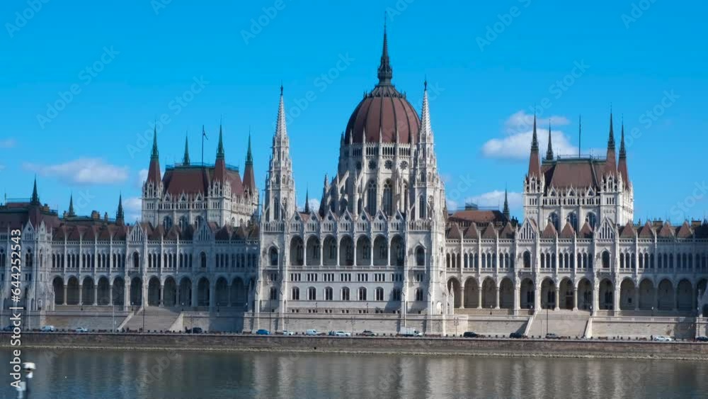 Hungarian parliament from the window of transport. A view of beautiful historical building of Hungary parliament against clear blue sky in summer. Hungarian parliament from the window of transport. A view of beautiful historical building of Hungary parliament against clear blue sky in summer.