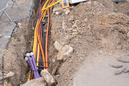 underground electric cable infrastructure communication installation. Construction site with various Cables protected in tubes. high-speed Internet Network cables are buried underground