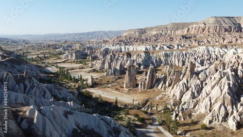 A drone shot of the Meskendir Valley, Cappadocia with a view of the Red Valley in the Background