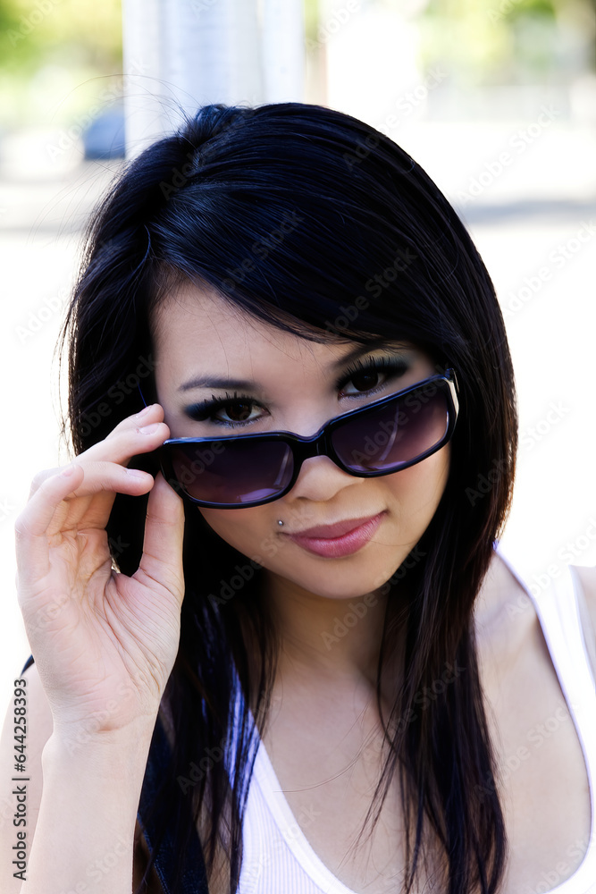 Outdoor Portrait Asian American Woman Looking Over Sunglasses Outdoor Portrait Asian American Woman Looking Over Sunglasses