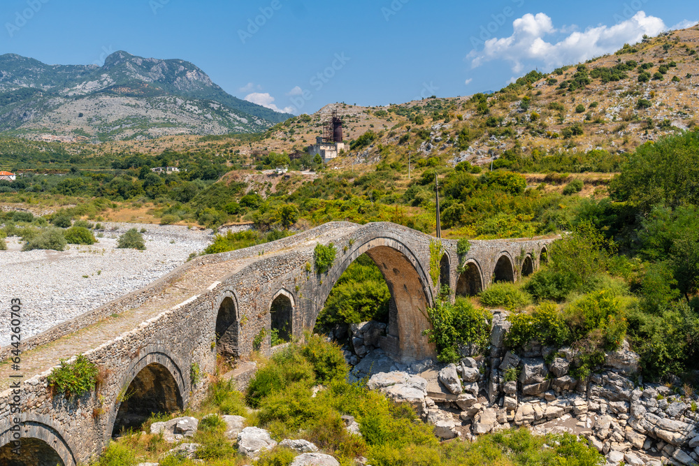Summer view of the Old Mes bridge near Shkoder. Albania, Europe. Ottoman stone arch bridge Ura e Kadiut