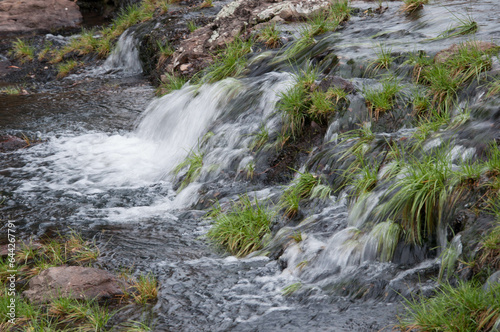 Water flowing over rocks in a small stream in the mountains 