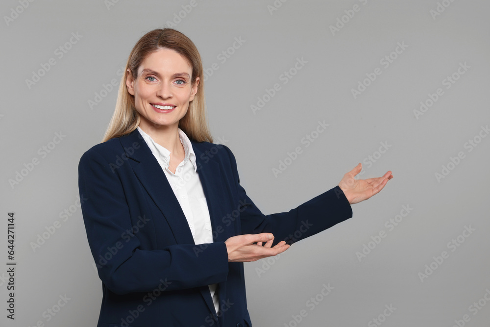 Happy real estate agent on grey background. Space for text Happy real estate agent on grey background. Space for text