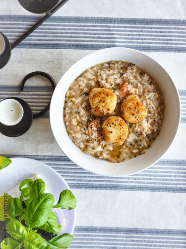 scallop risotto next to a basil plant