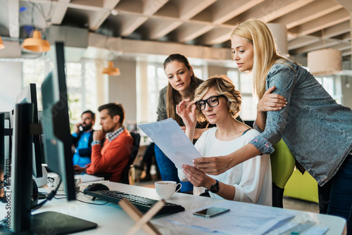 Young and diverse group of women working together in a startup company office