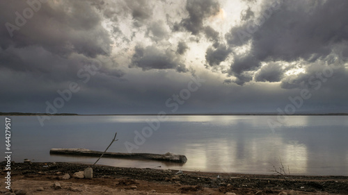 Atardecer gris en el lago , una tarde plomiza anunciando la llegada del invierno , dique el carrizal Mendoza. photo
