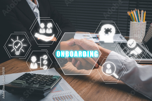 Business onboarding concept, Business partnership handshaking after perfect deal with onbaording icon on virtual screen background, Organizational, socialization.