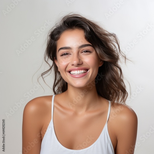 Fototapeta portrait of a beautiful young latin model woman laughing and smiling with clean