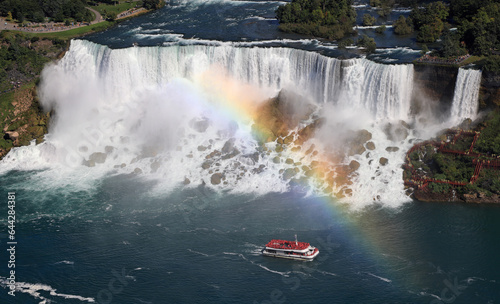 Aerial view of American and Bridal Veil Falls including the rainbow and Hornblower Boat sailing on Niagara River, Canada and USA natural border