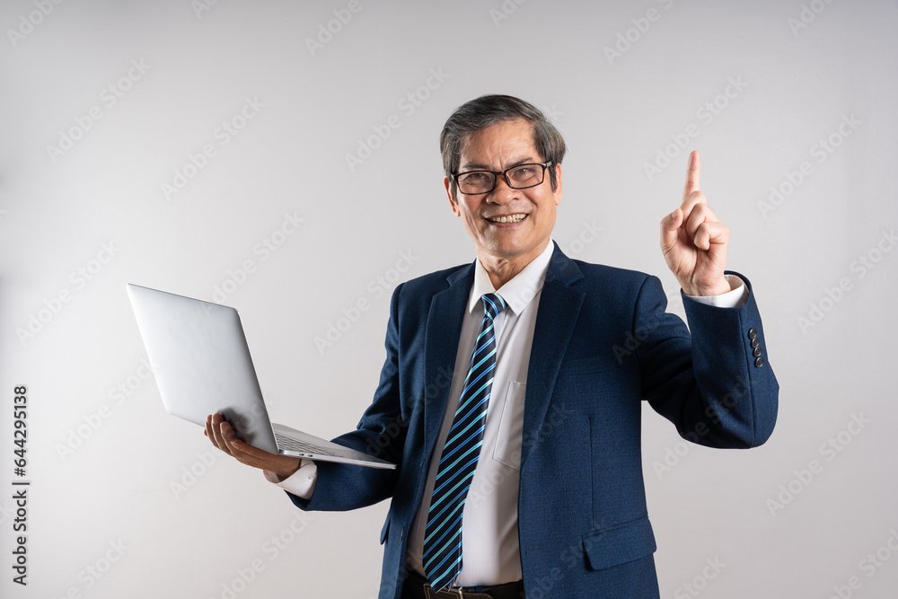Portrait of an elderly Asian businessman, posing on a blue background Portrait of an elderly Asian businessman, posing on a blue background