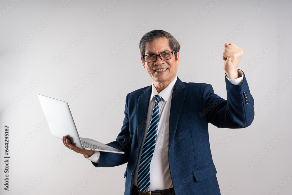 Portrait of an elderly Asian businessman, posing on a blue background