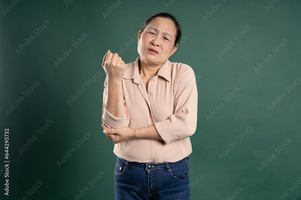 Gangang middle-aged Asian female portrait posing on blue background