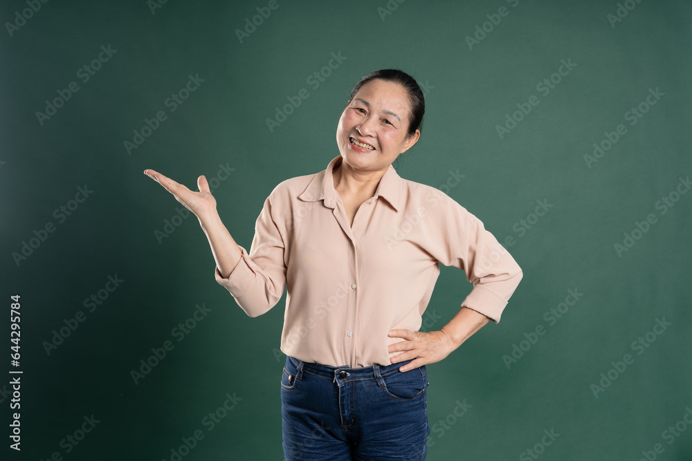 Gangang middle-aged Asian female portrait posing on blue background Gangang middle-aged Asian female portrait posing on blue background
