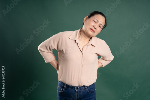 Gangang middle-aged Asian female portrait posing on blue background