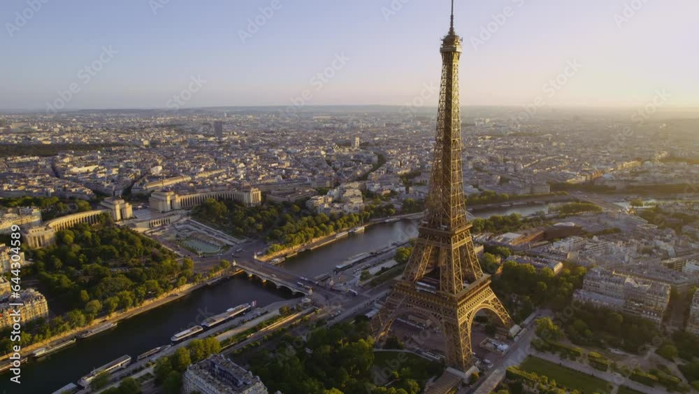 Aerial view of the Eiffel Tower and the Seine River with the city of Paris, France in the background at sunrise. Cinematic 4k.