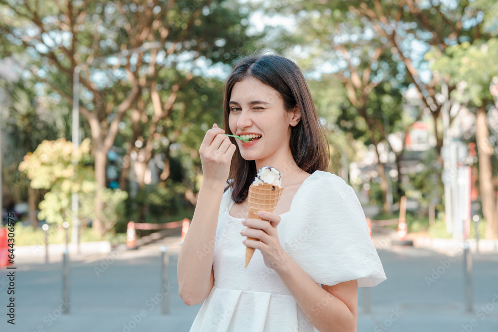 Portrait of happy young woman with delicious ice cream in waffle cone outdoors. Portrait of happy young woman with delicious ice cream in waffle cone outdoors.