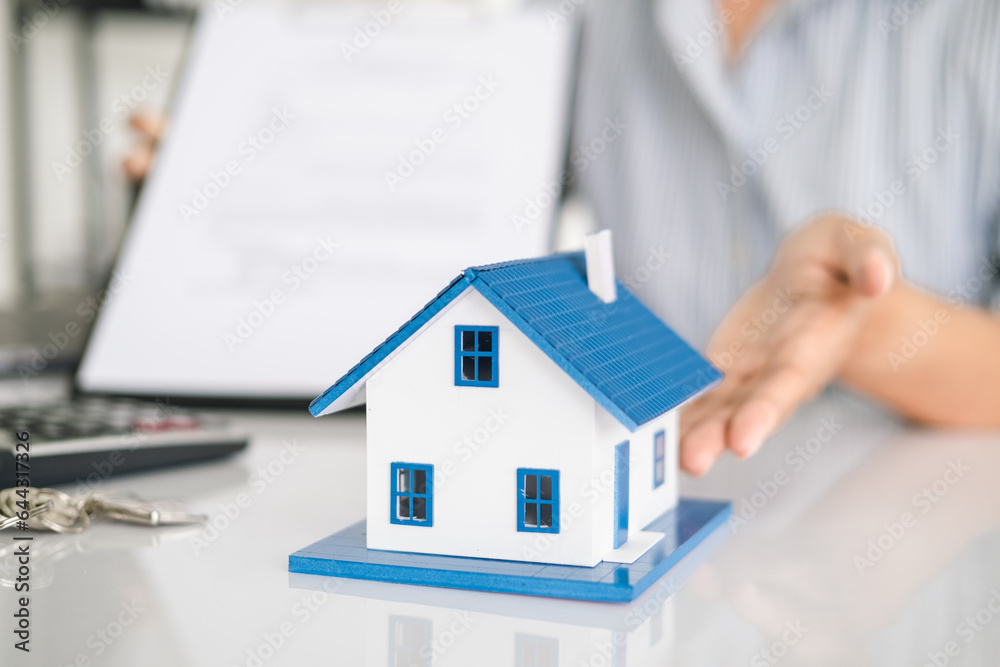 real estate agents talk about renting or buying a home in the office. real estate agents talk about renting or buying a home in the office.