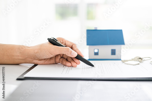 Sales manager or real estate agent will be prepared to show you a sample home and detail the terms of buying a home with insurance promotions, Attention to property services and insurance concept.