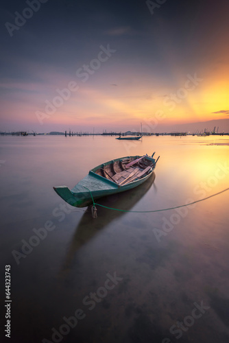 Fishing boat in the water at sunset. Beautiful sunset over the sea