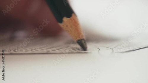 macro shot of a pencil sketching shadows on a drawing