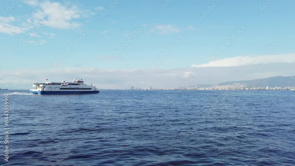 Daytime view of a passenger ship departing from Alsancak Port in Izmir, with the deep blue sea seen from Izmir's Kordon.