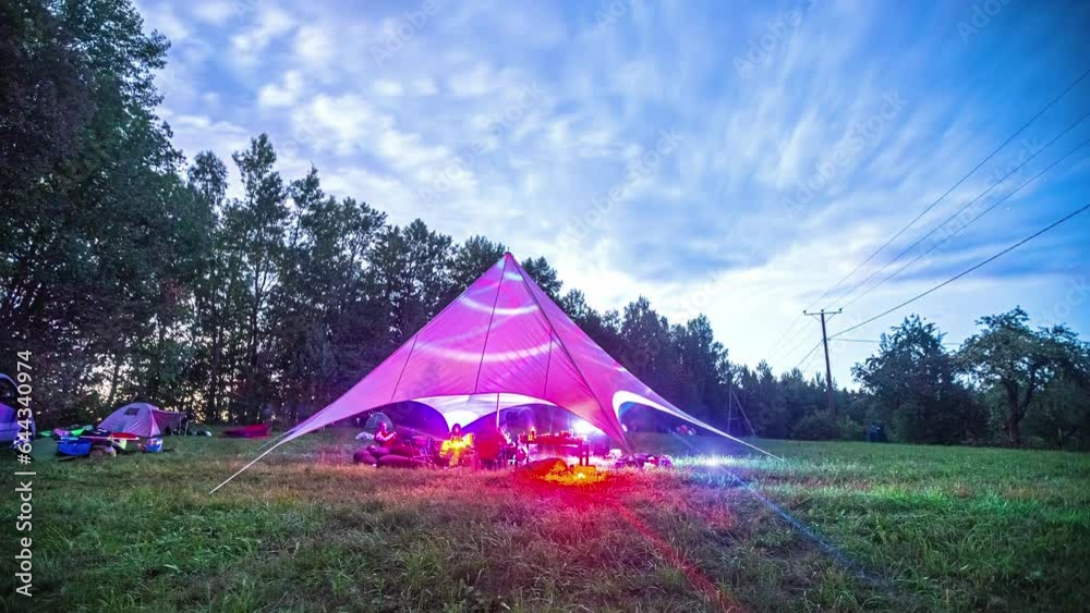 Cinematic timelapse of a colorful party tent with neon colors going from daytime to nighttime Cinematic timelapse of a colorful party tent with neon colors going from daytime to nighttime