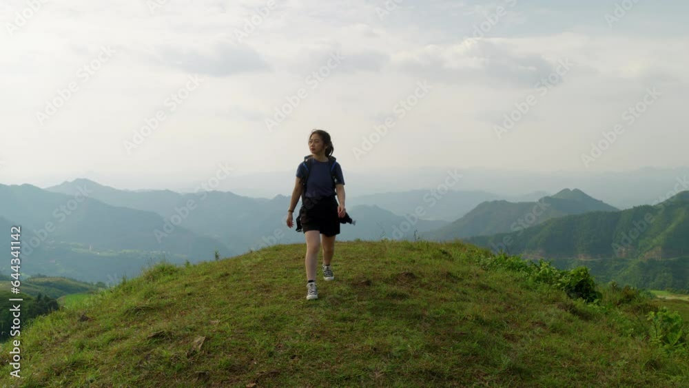 young asiatic female solo traveller walking in slow motion hiking mountains peak in remote natural travel destination young asiatic female solo traveller walking in slow motion hiking mountains peak in remote natural travel destination
