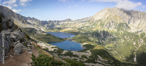 Beautiful alpine valley with mountain peaks, lakes, and some vegetation, panoramic, Poland, Europe