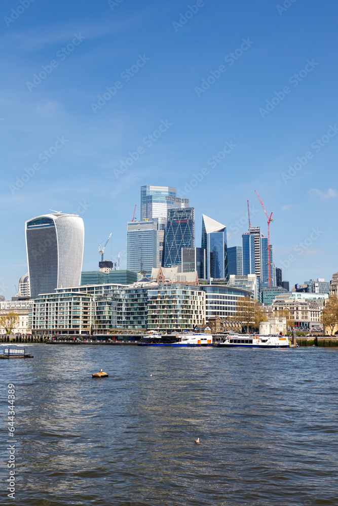 London city skyline with skyscrapers in the financial district at Thames River portrait format