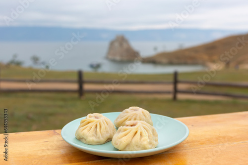 National Buryat Food on the Table on Blur Lake Baikal Background
