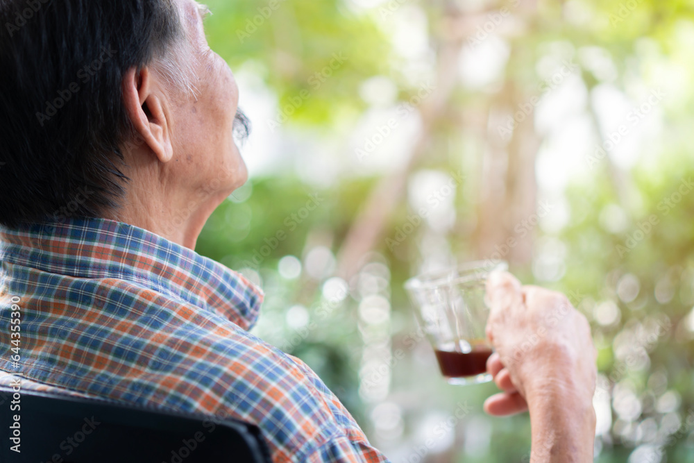 Back view shot of happy older Asian man holding a cup of coffee at home, retired old people healthy lifestyle. Back view shot of happy older Asian man holding a cup of coffee at home, retired old people healthy lifestyle.