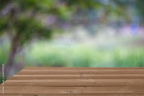 wooden table with bokeh garden background
