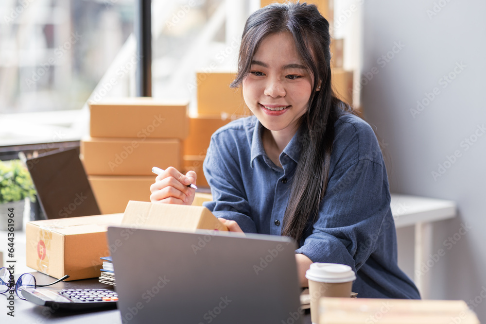 Small business aspiring young asian entrepreneur SME, small and medium business freelance worker working in a home office.SME online business ideas. Small business aspiring young asian entrepreneur SME, small and medium business freelance worker working in a home office.SME online business ideas.