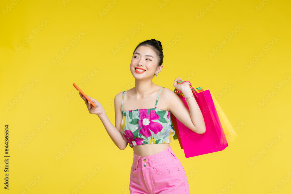 young woman holding shopping bags and smart phone young woman holding shopping bags and smart phone
