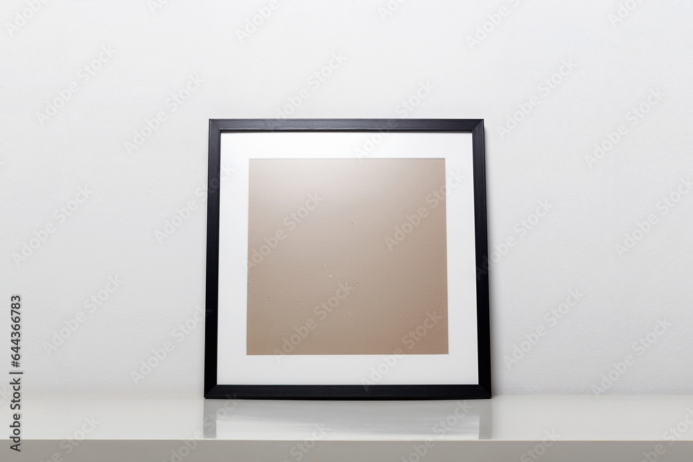 black picture frame on a table. Stylish photoframe with passe-partout black picture frame on a table. Stylish photoframe with passe-partout
