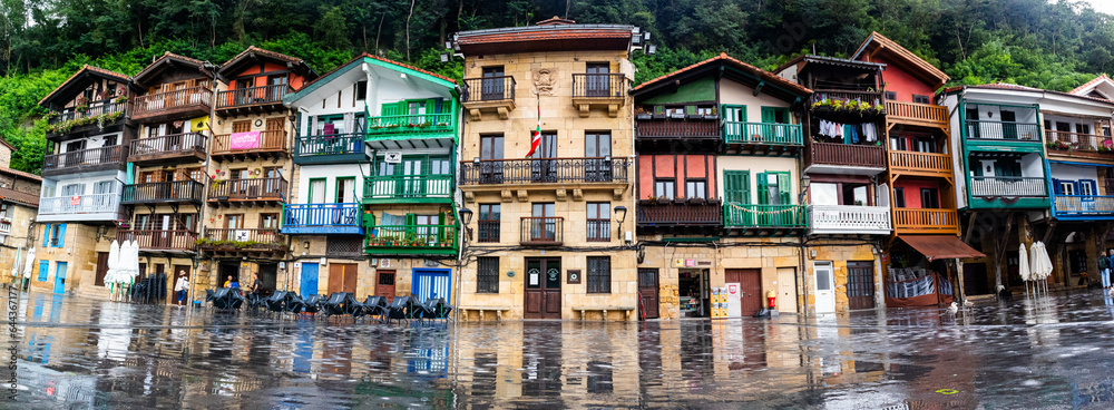 Loads of colourfoul houses in the main square of an old town with a rainny day making a reflection in the floor