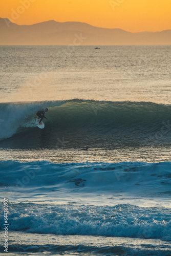 Photography silhouette of a person surfing on the beach a barrel