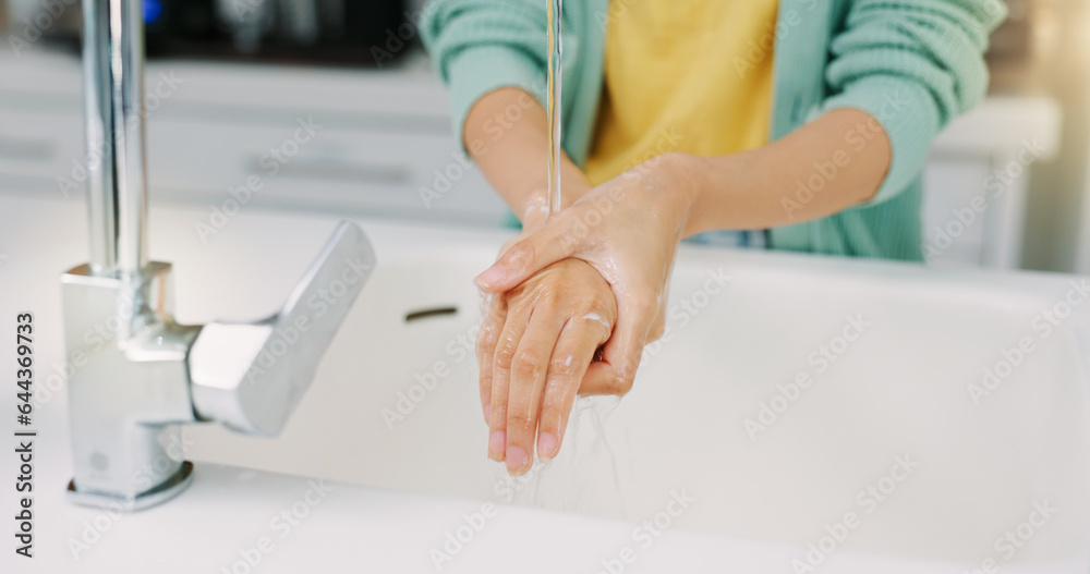 Washing hands, woman cleanse and kitchen sink of a female with soap for cleaning and wellness. Home, safety and virus protection of a person with healthcare in a house for skincare and grooming