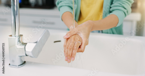 Washing hands, woman cleanse and kitchen sink of a female with soap for cleaning and wellness. Home, safety and virus protection of a person with healthcare in a house for skincare and grooming