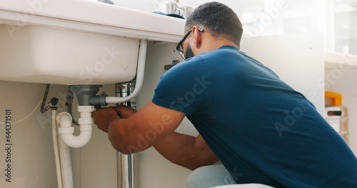 Plumber black man  kitchen and sink maintenance with tools  focus and pipe repair for drainage in home. Entrepreneur handyman  plumbing expert or small business owner in house for fixing water system