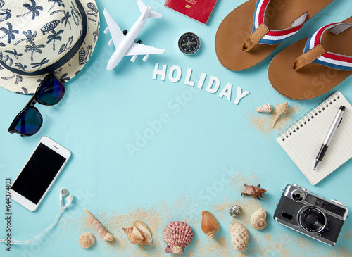 top view of travel gadgets on blue background for holiday concept