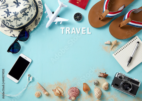 top view of travel gadgets on blue background for travel concept