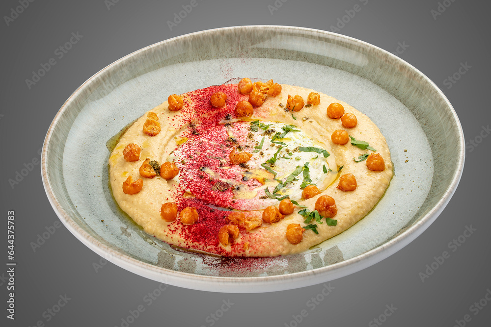 Chickpea hummus on decorative ceramic plate. Gray background. Chickpea hummus on decorative ceramic plate. Gray background.