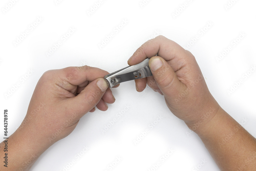 Male hand manicure with nail clipper isolated on white background Male hand manicure with nail clipper isolated on white background