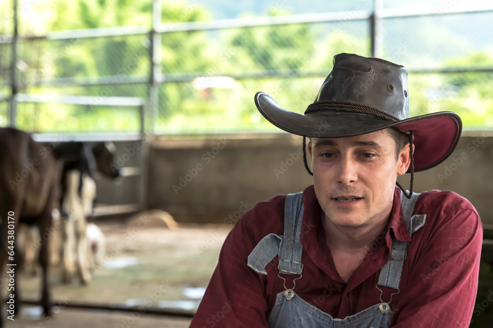 Young cowboy in cow farming