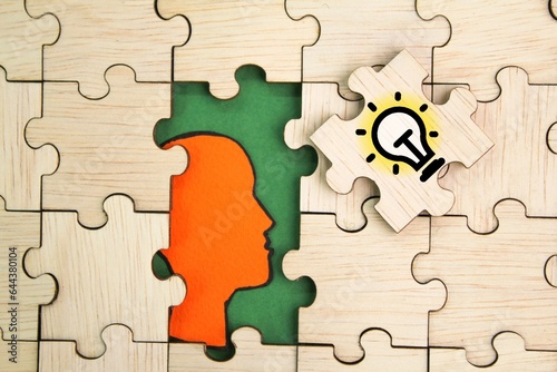 wooden puzzle with idea icon and human head. New idea,Creative idea,Inspiration, Creative Thinking ,Education or Learning concept. Business Thinking