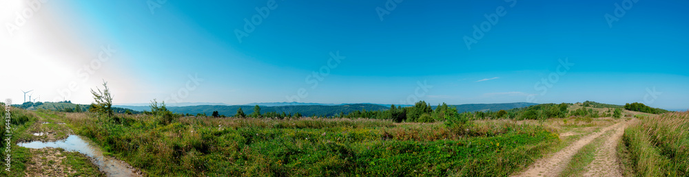 Wind turbine for alternative energy in mountain landscape with clear space background. The concept of clean energy, eco-energetics of the wind. Wind turbine for alternative energy in mountain landscape with clear space background. The concept of clean energy, eco-energetics of the wind.
