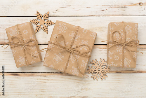 Craft christmas gift boxes on wooden background, top view