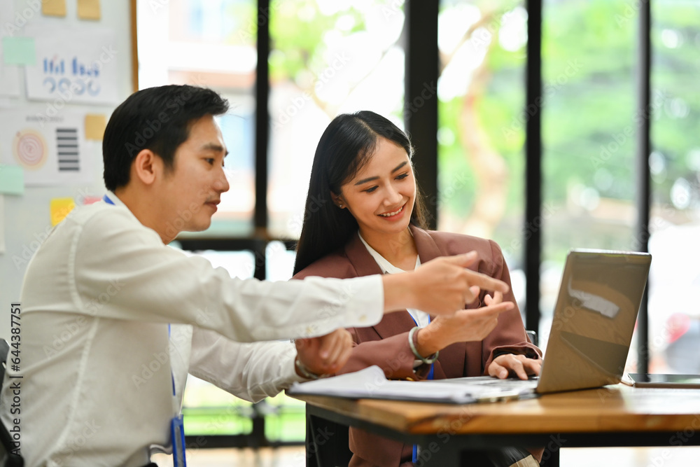Businesspeople having fun cooperating working together on a new project in an office Businesspeople having fun cooperating working together on a new project in an office