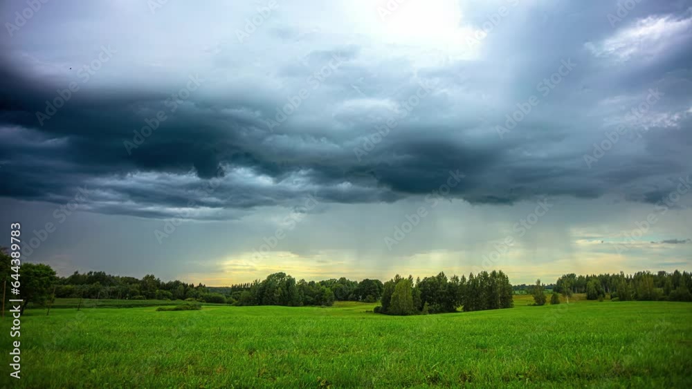 Rain clouds slide over a green landscape with trees and meadows. Rain clouds slide over a green landscape with trees and meadows.